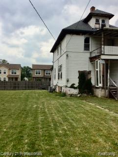2118 Vinewood St, Detroit, MI 48216 - rear view of property with a chimney