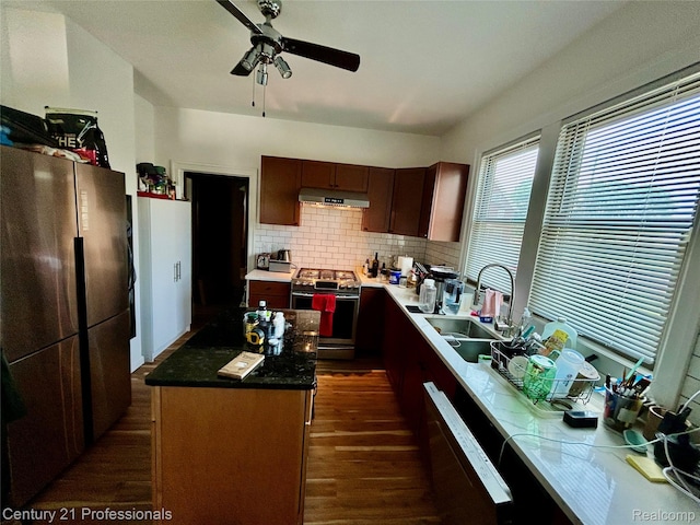 2118 Vinewood St, Detroit, MI 48216 - kitchen with stainless steel gas range, freestanding refrigerator, under cabinet range hood, dark wood-style flooring, and ceiling fan