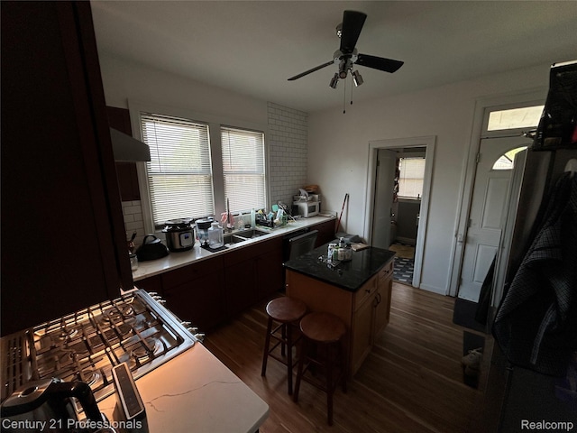 2118 Vinewood St, Detroit, MI 48216 - kitchen featuring dark wood-style flooring, ceiling fan, a center island, dishwasher, and wall chimney exhaust hood