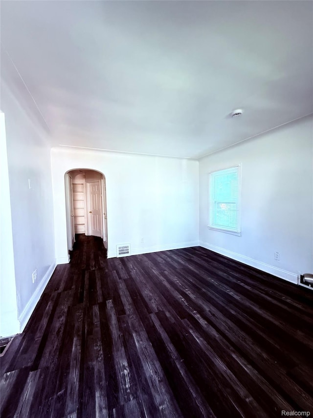 9941 Minock St, Detroit, MI 48228 - unfurnished room featuring wood finished floors, arched walkways, and a smoke detector