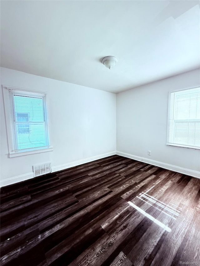9941 Minock St, Detroit, MI 48228 - unfurnished room with dark wood-style floors and healthy amount of natural light