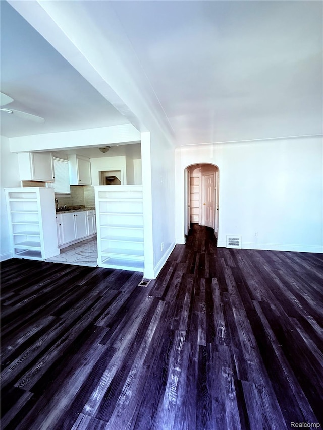9941 Minock St, Detroit, MI 48228 - unfurnished living room with wood finished floors and arched walkways