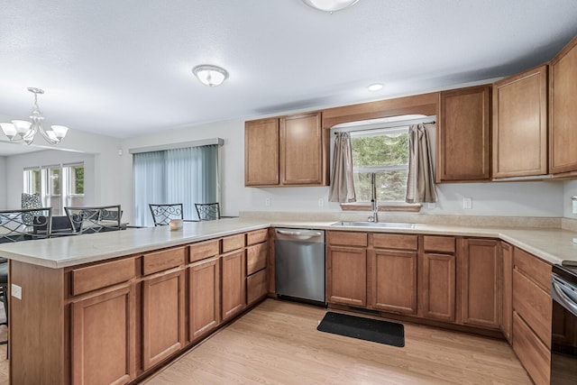 1860 Partridge Ln, Kalamazoo, MI 49009 - kitchen with dishwasher, a peninsula, brown cabinetry, a chandelier, and light countertops