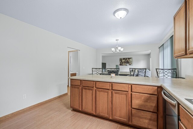 1860 Partridge Ln, Kalamazoo, MI 49009 - kitchen featuring dishwasher, brown cabinets, a peninsula, and light countertops
