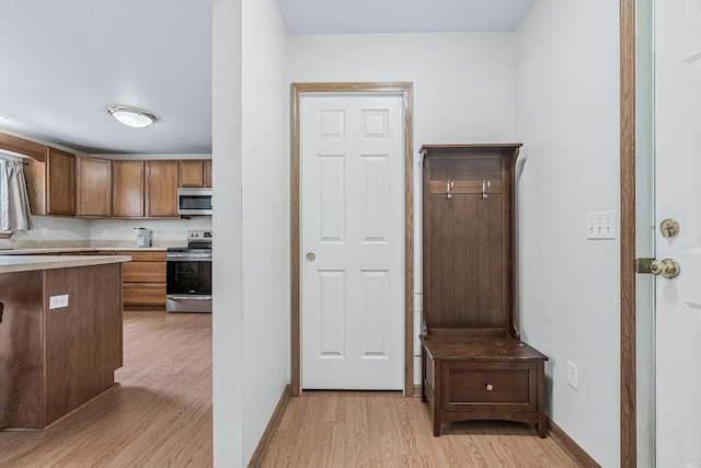 1860 Partridge Ln, Kalamazoo, MI 49009 - kitchen featuring stainless steel appliances, light wood-style floors, and light countertops