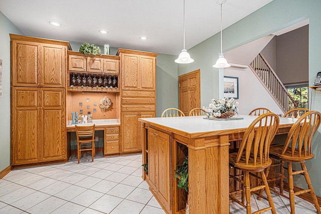11683 Fair Lk, Delton, MI 49046 - kitchen with a kitchen breakfast bar, hanging light fixtures, recessed lighting, light tile patterned floors, and light countertops