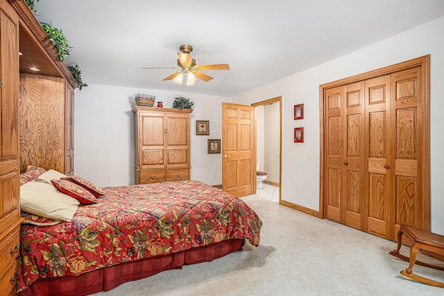 11683 Fair Lk, Delton, MI 49046 - bedroom with light carpet, ensuite bath, ceiling fan, and a closet
