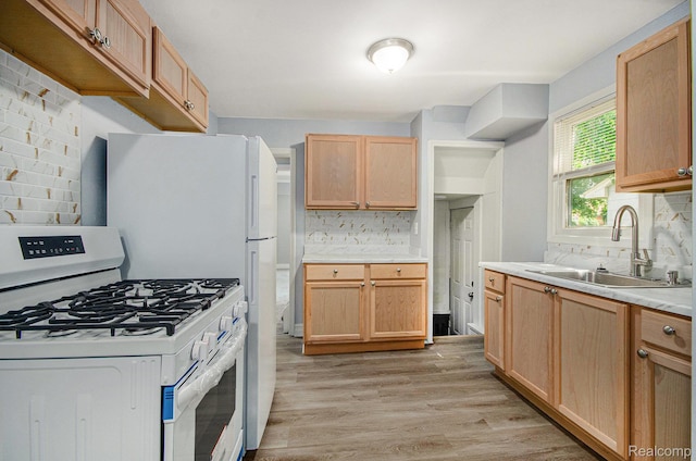 38 E Ypsilanti Ave, Southfield, MI 48340 - kitchen with white range with gas cooktop, backsplash, light countertops, light wood-style floors, and light brown cabinets