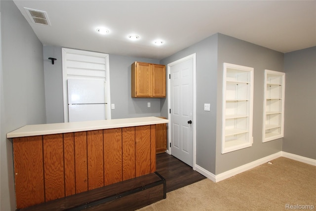 29716 Joy Rd, Livonia, MI 48150 - kitchen with freestanding refrigerator, brown cabinetry, a peninsula, dark colored carpet, and light countertops