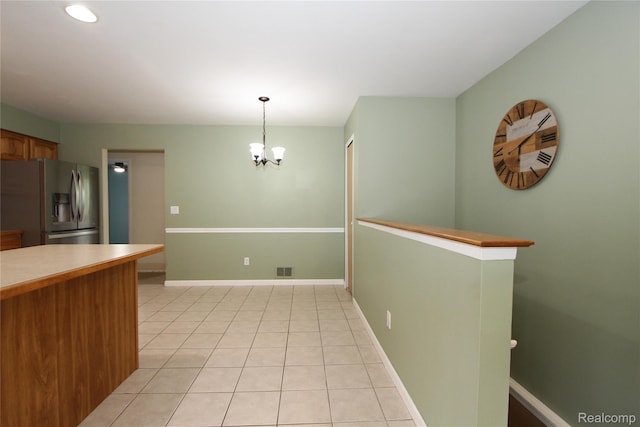 29716 Joy Rd, Livonia, MI 48150 - kitchen featuring stainless steel fridge with ice dispenser, a chandelier, light tile patterned floors, decorative light fixtures, and brown cabinetry