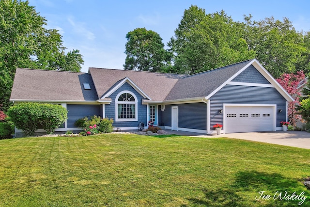 278 Caravan Rd, Norton Shores, MI 49441 - view of front of house featuring an attached garage, concrete driveway, a front yard, and a shingled roof