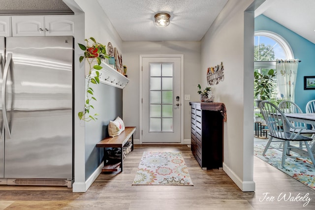 278 Caravan Rd, Norton Shores, MI 49441 - entrance foyer featuring light wood-type flooring and a textured ceiling