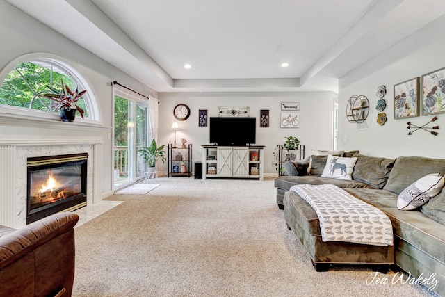 278 Caravan Rd, Norton Shores, MI 49441 - living room featuring carpet, a raised ceiling, a fireplace, and recessed lighting