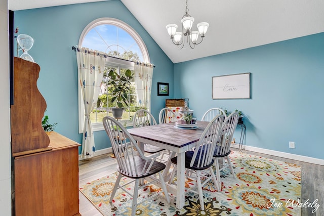278 Caravan Rd, Norton Shores, MI 49441 - dining space featuring a chandelier, light wood-style flooring, plenty of natural light, and high vaulted ceiling