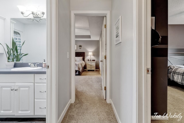 278 Caravan Rd, Norton Shores, MI 49441 - corridor featuring light colored carpet and a chandelier