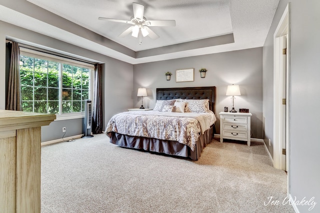 278 Caravan Rd, Norton Shores, MI 49441 - bedroom with carpet floors, a raised ceiling, and ceiling fan