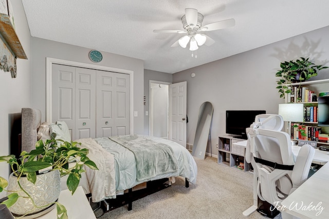 278 Caravan Rd, Norton Shores, MI 49441 - carpeted bedroom with a closet, a ceiling fan, a textured ceiling, and an office area