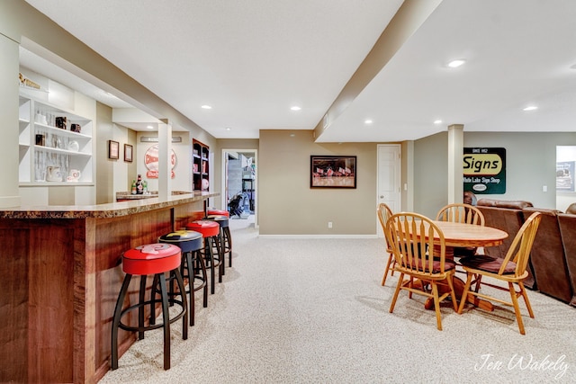 278 Caravan Rd, Norton Shores, MI 49441 - dining space with a bar, light carpet, and recessed lighting