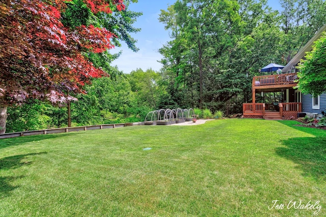 278 Caravan Rd, Norton Shores, MI 49441 - view of grassy yard featuring a deck