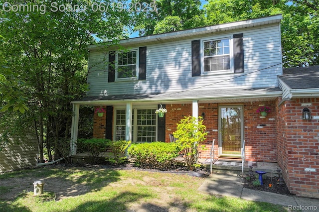 12260 Dollar Lake Dr, Fenton, MI 48430 - traditional home featuring brick siding and a porch