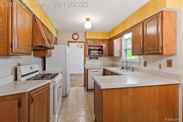 12260 Dollar Lake Dr, Fenton, MI 48430 - kitchen with white appliances, a peninsula, and brown cabinets