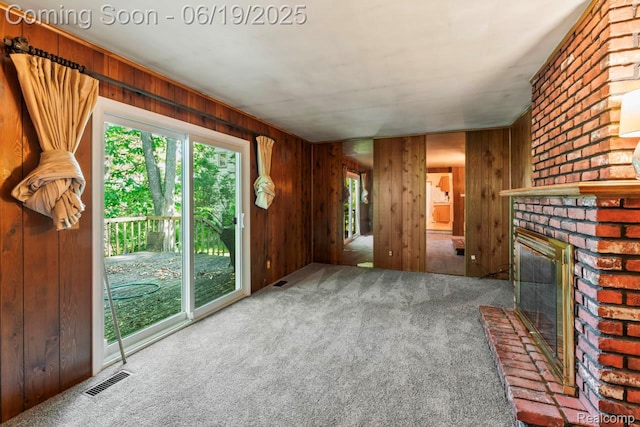 12260 Dollar Lake Dr, Fenton, MI 48430 - unfurnished living room with carpet, wooden walls, and a brick fireplace