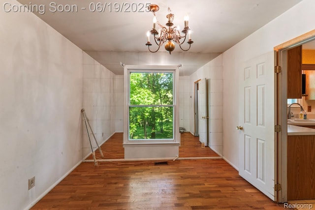 12260 Dollar Lake Dr, Fenton, MI 48430 - unfurnished room with wood finished floors and a chandelier