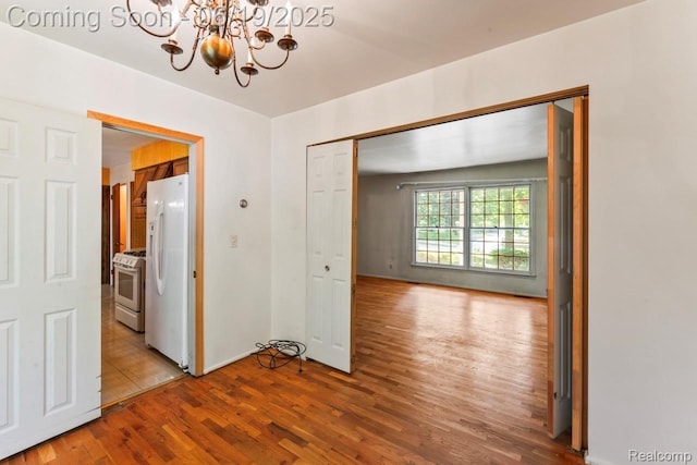 12260 Dollar Lake Dr, Fenton, MI 48430 - hallway featuring a chandelier and wood finished floors