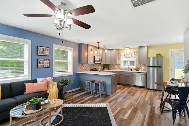 8368 N 46th St, Augusta, MI 49012 - kitchen with stainless steel appliances, light wood finished floors, light countertops, and tasteful backsplash
