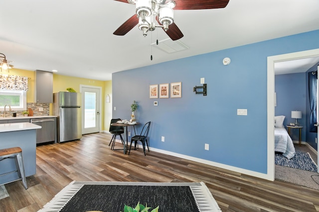 8368 N 46th St, Augusta, MI 49012 - kitchen featuring appliances with stainless steel finishes, light countertops, a ceiling fan, dark wood finished floors, and backsplash