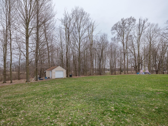 8368 N 46th St, Augusta, MI 49012 - view of green lawn with a playground, an outbuilding, and a garage