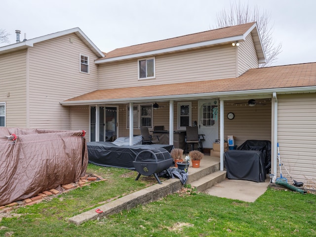 8368 N 46th St, Augusta, MI 49012 - back of house featuring ceiling fan, a lawn, and a patio area