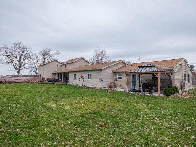 8368 N 46th St, Augusta, MI 49012 - rear view of house featuring a gazebo, a patio, a lawn, and roof with shingles