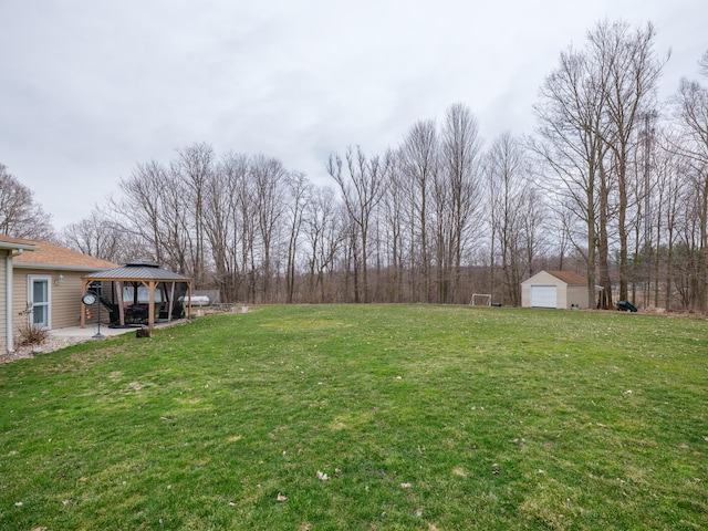 8368 N 46th St, Augusta, MI 49012 - view of green lawn with a gazebo, a patio area, a detached garage, and an outdoor structure
