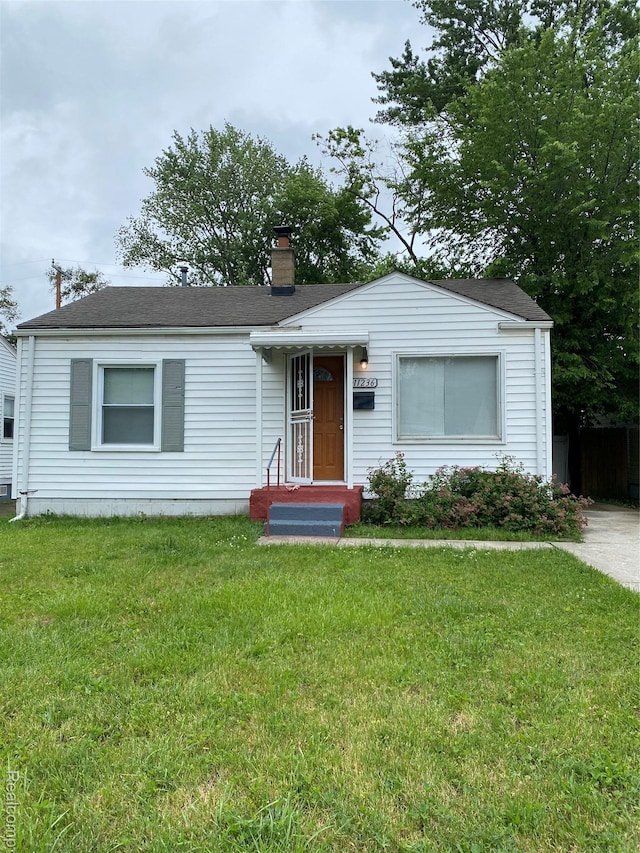 11236 Studebaker Ave, Warren, MI 48089 - view of front of property with a chimney and a front lawn