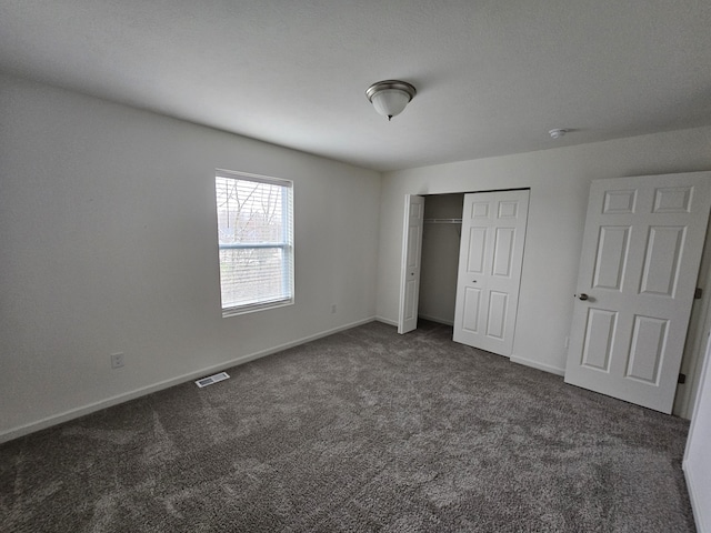 8781 Prairie Stone Dr SW, Byron Center, MI 49315 - unfurnished bedroom with dark colored carpet and a closet