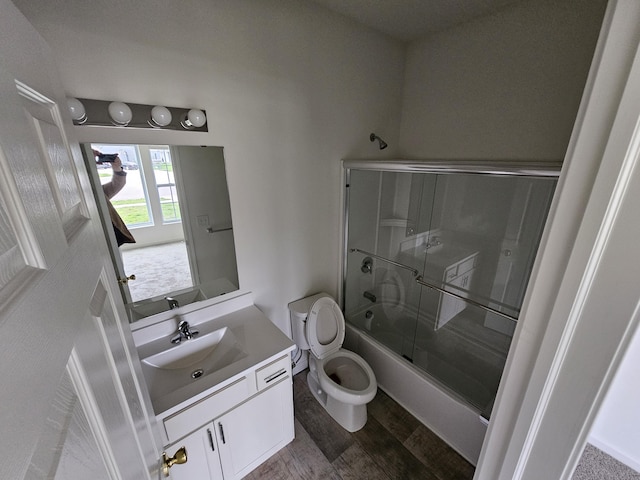 8781 Prairie Stone Dr SW, Byron Center, MI 49315 - full bathroom featuring vanity, bath / shower combo with glass door, and wood finished floors