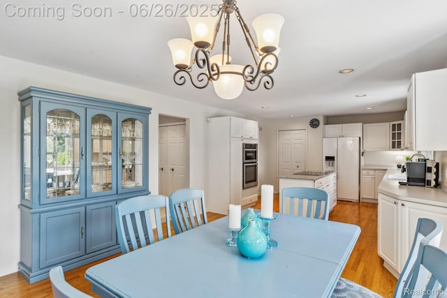 5520 Huron Hills Dr, Commerce Twp, MI 48382 - dining area with a chandelier, light wood-style floors, and recessed lighting