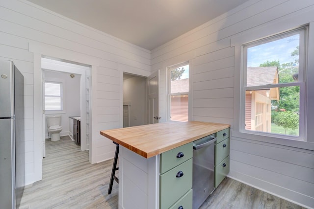 28 E Southern Ave, Muskegon, MI 49442 - kitchen featuring wooden counters, appliances with stainless steel finishes, green cabinets, light wood-style flooring, and wood walls