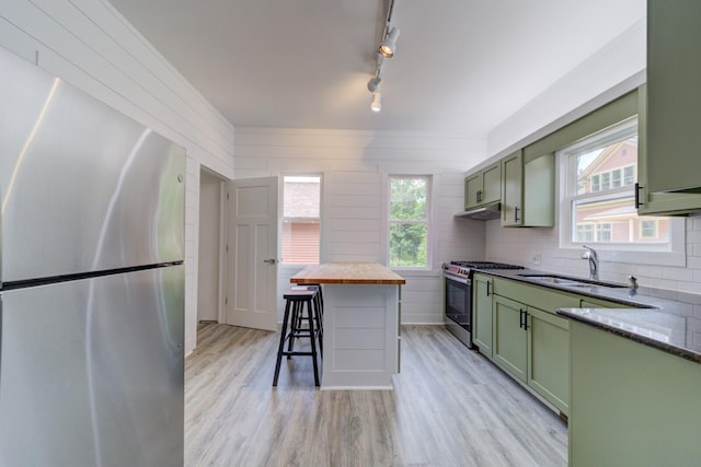 28 E Southern Ave, Muskegon, MI 49442 - kitchen featuring green cabinetry, appliances with stainless steel finishes, light wood-type flooring, wood counters, and rail lighting