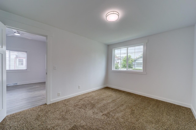 28 E Southern Ave, Muskegon, MI 49442 - carpeted empty room with baseboards and ceiling fan
