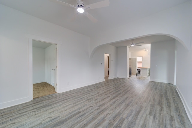 28 E Southern Ave, Muskegon, MI 49442 - unfurnished living room featuring ceiling fan, arched walkways, and wood finished floors