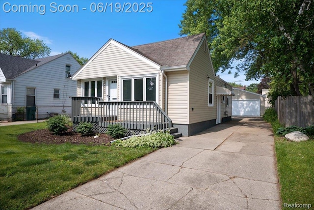 2755 Royal Ave, Berkley, MI 48072 - view of front facade with a garage, a shingled roof, and an outbuilding