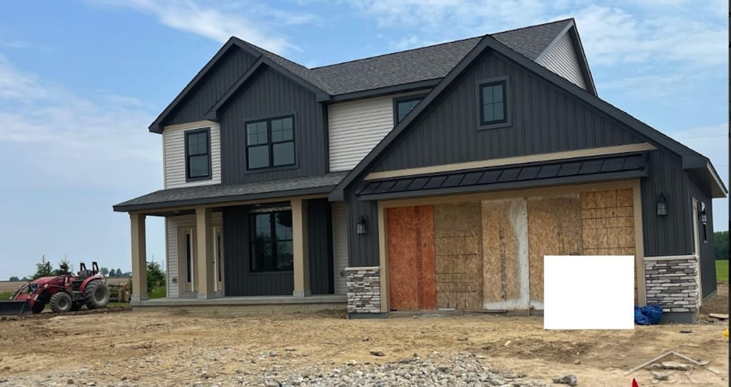 535 Queens Creek Dr, Frankenmuth, MI 48734 - modern inspired farmhouse with covered porch, a shingled roof, a standing seam roof, board and batten siding, and a metal roof