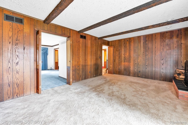 23719 Wendy Ln, Southfield, MI 48075 - carpeted spare room featuring beam ceiling, wooden walls, and a textured ceiling