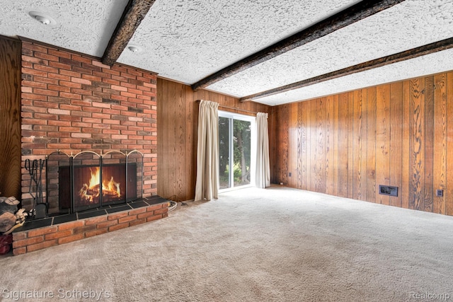 23719 Wendy Ln, Southfield, MI 48075 - unfurnished living room featuring wooden walls, beam ceiling, carpet floors, a brick fireplace, and a textured ceiling