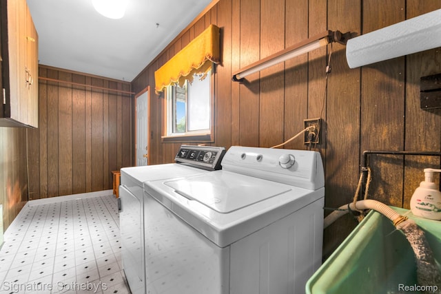 23719 Wendy Ln, Southfield, MI 48075 - washroom with independent washer and dryer, wood walls, and light flooring