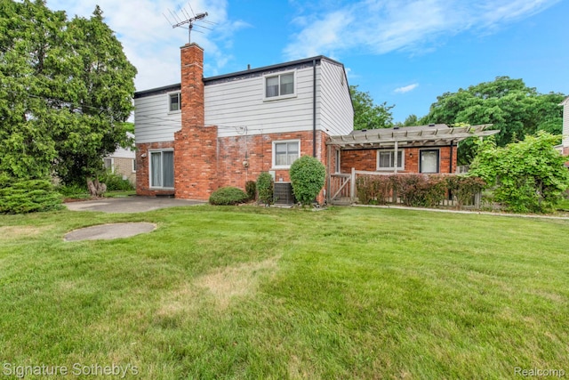 23719 Wendy Ln, Southfield, MI 48075 - back of house with a pergola, a chimney, brick siding, and a yard