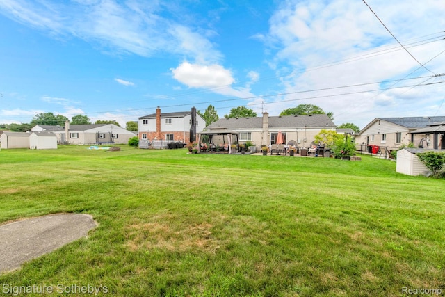 23719 Wendy Ln, Southfield, MI 48075 - view of yard with a gazebo, a storage unit, and a residential view