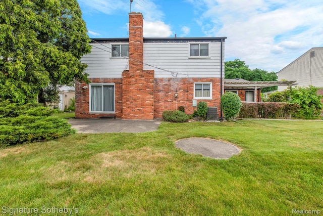 23719 Wendy Ln, Southfield, MI 48075 - rear view of house featuring brick siding, a lawn, a chimney, and a patio area